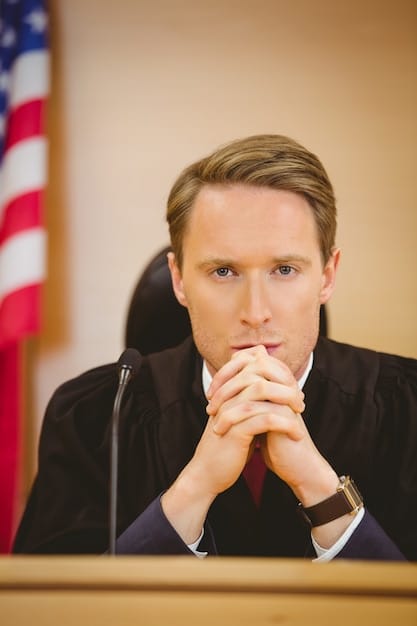 Close-up photograph of a Supreme Court nominee testifying before the Senate Judiciary Committee, showcasing the intensity and scrutiny of the confirmation hearings. Capture the nominee answering questions from senators, with a focus on their expressions and body language to convey the pressure and importance of the situation.