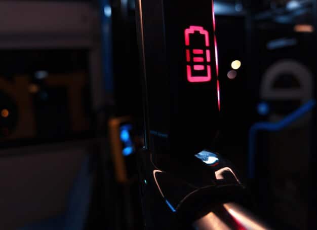 A close-up of an EV charging station, highlighting the connection point and the digital display showing the charging progress.