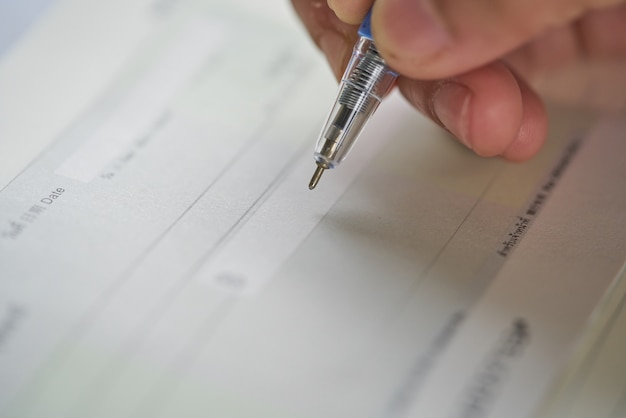 A close-up of a tax form with a pen pointing to the section about the Child Tax Credit. The form is partially filled out, showing numbers and calculations relevant to claiming the credit. The background is blurred, focusing on the form and the pen.