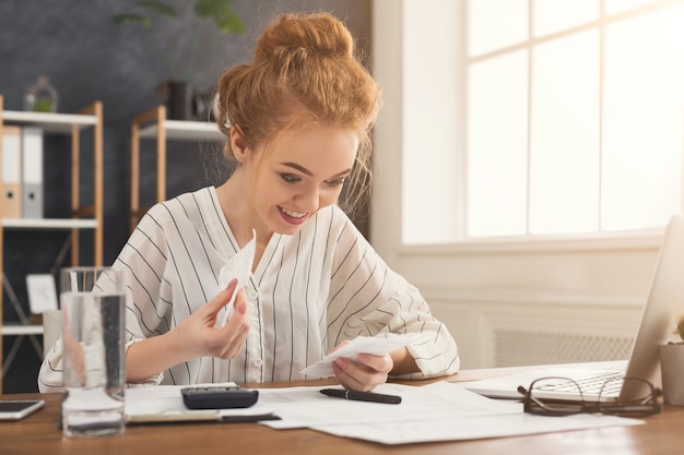 A person is sitting at a desk, using a calculator and referring to tax documents. They are focused and determined, looking for ways to maximize their Child Tax Credit benefits. The scene conveys a sense of empowerment and financial responsibility.