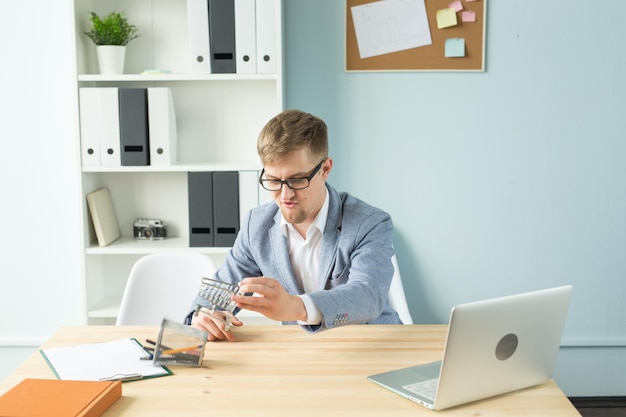 A person sitting at a desk reviewing tax documents and using a calculator, with a laptop displaying tax-related information, symbolizing the individual taxpayer's effort to understand and comply with tax laws.