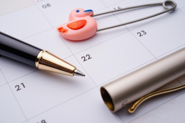 A close-up of a calendar highlighting the dates of the healthcare benefits enrollment period, with a pen and calculator nearby, symbolizing planning and financial considerations.