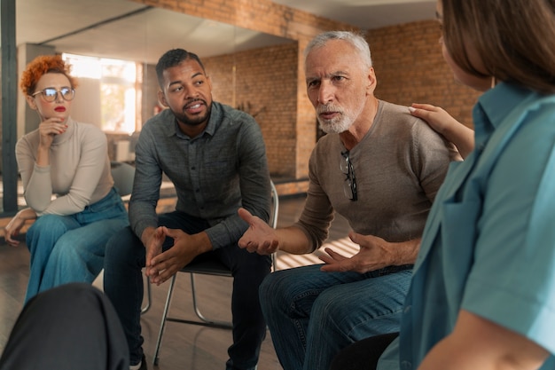 A diverse group of veterans participating in a group therapy session, highlighting the importance of mental health support and community within veteran healthcare programs.