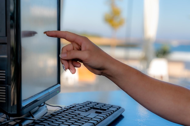 A close-up of a hand pointing to a computer screen displaying a state government website's unclaimed property search page. The atmosphere is bright and optimistic.